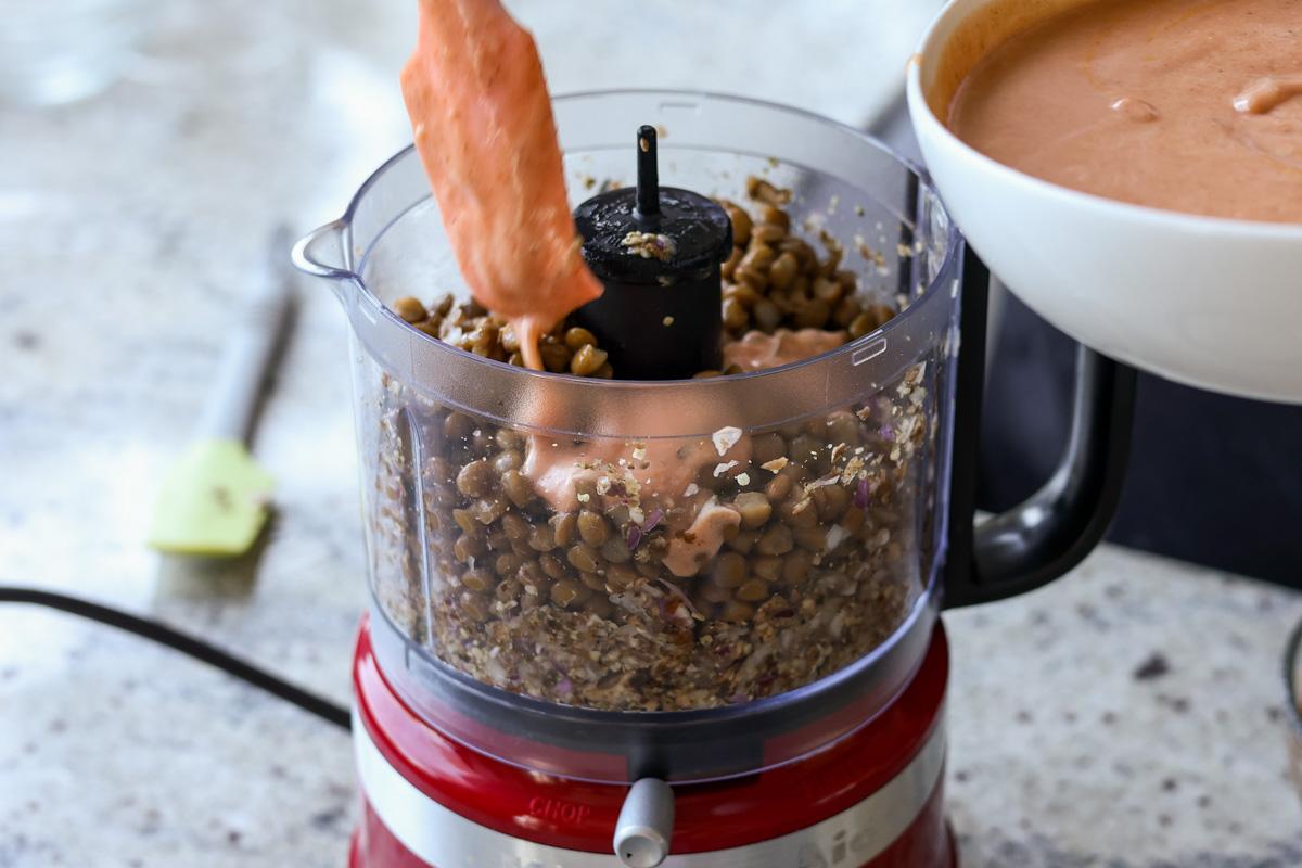 adding butter chicken sauce to the food processor