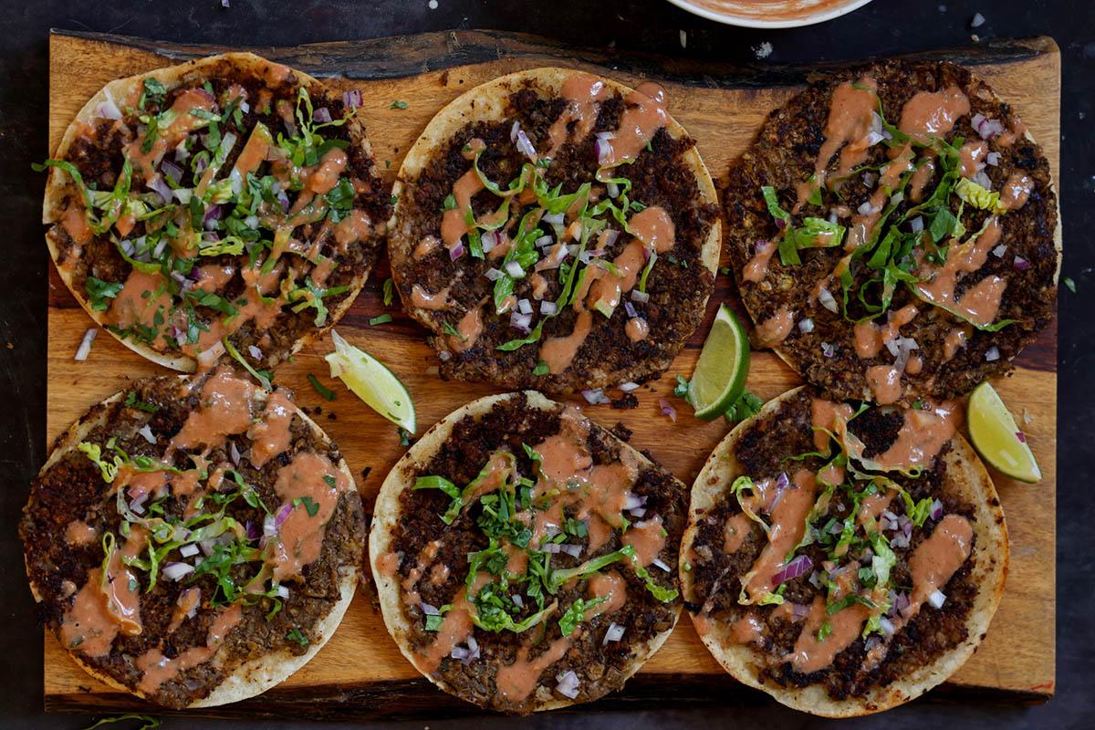 butter chicken smashed tacos on a serving tray