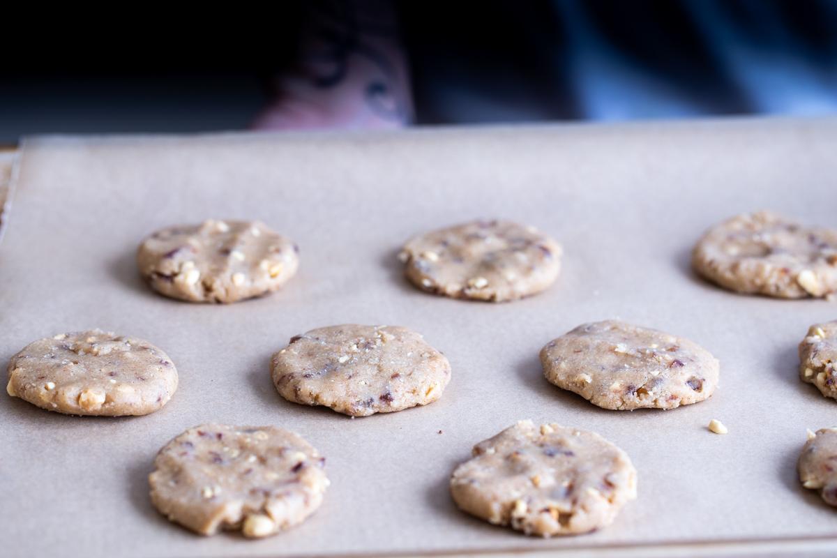 unbaked vegan snickers cookies on a cookie sheet