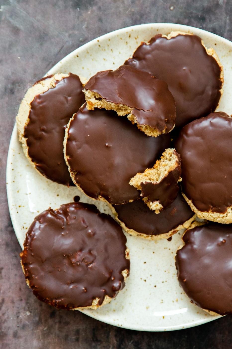 a plate of vegan glutenfree almond flour snickers cookies covered with chocolate glaze