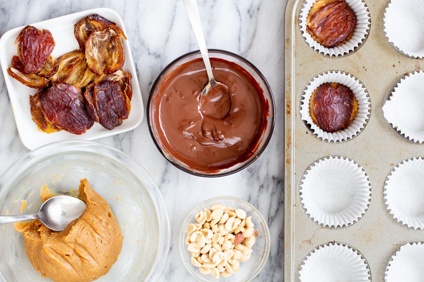 halved pitted dates being added to chocolate peanut butter cups