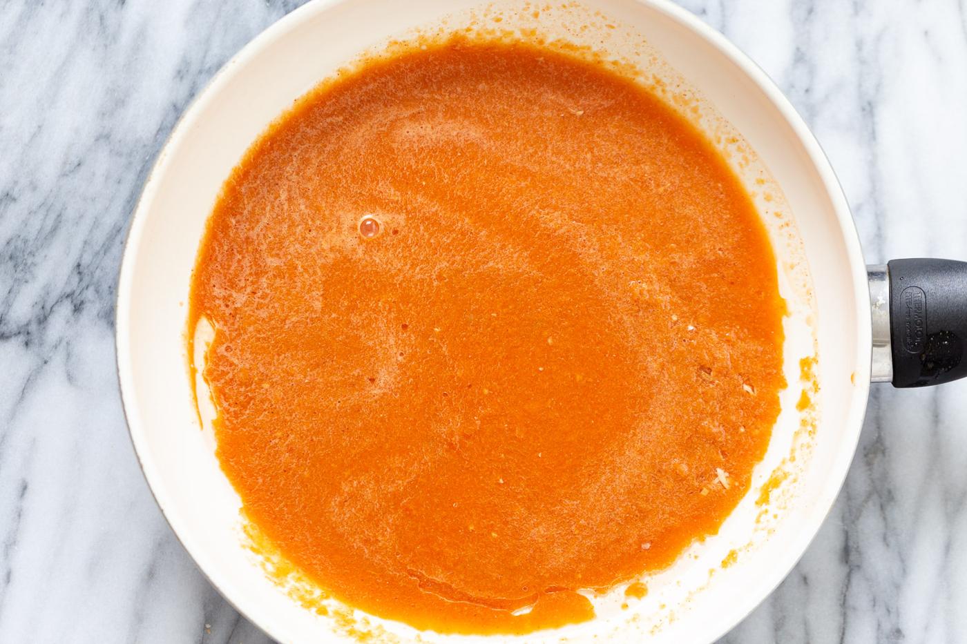 overhead shot of a pan with tomato sauce base used for making Spanish Cauliflower rice