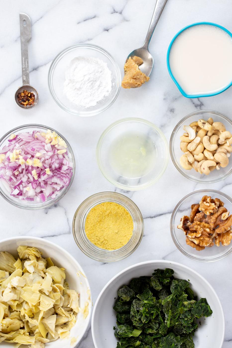 Vegan Spinach Artichoke Dip Ingredients in bowls and measuring cups