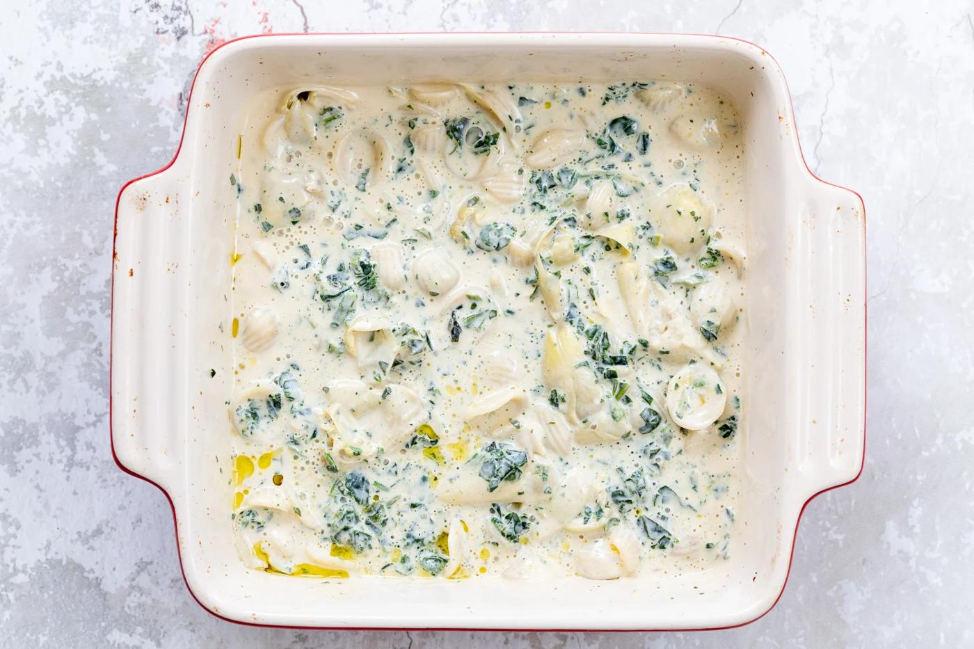 spinach artichoke pasta bake ready to go in the oven