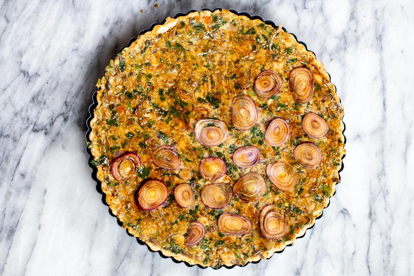 vegan quiche being glazed with worcestershire sauce