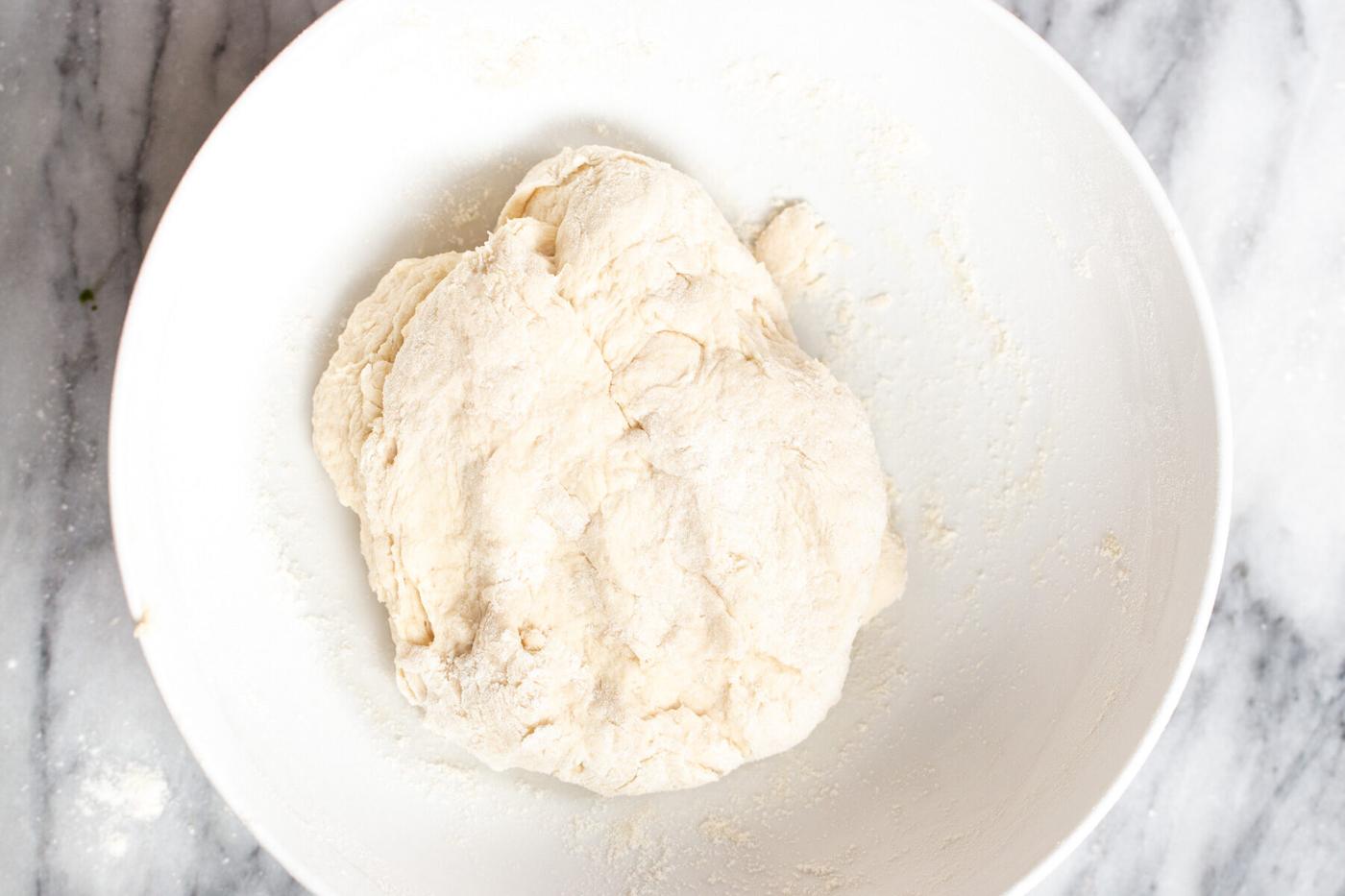 naan bread dough in a white bowl