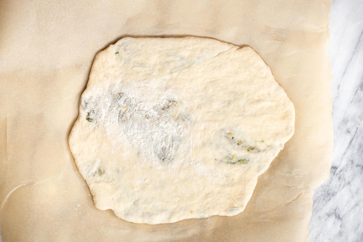 vegan spinach stuffed naan on a piece of baking paper