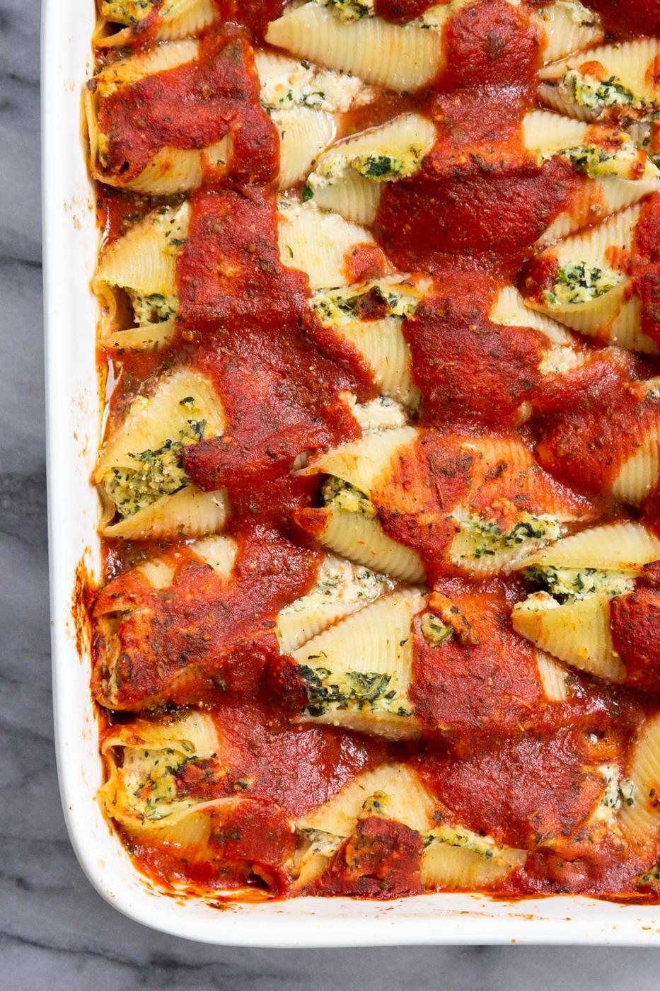 overhead shot of a casserole dish with vegan stuffed shells covered in marinara sauce