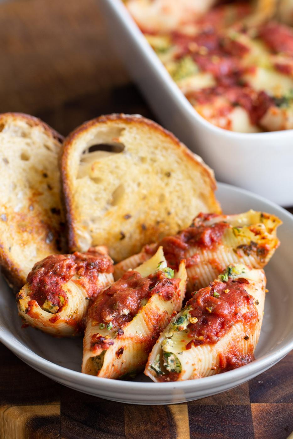 vegan spinach and ricotta stuffed shells served with two slices of white bread