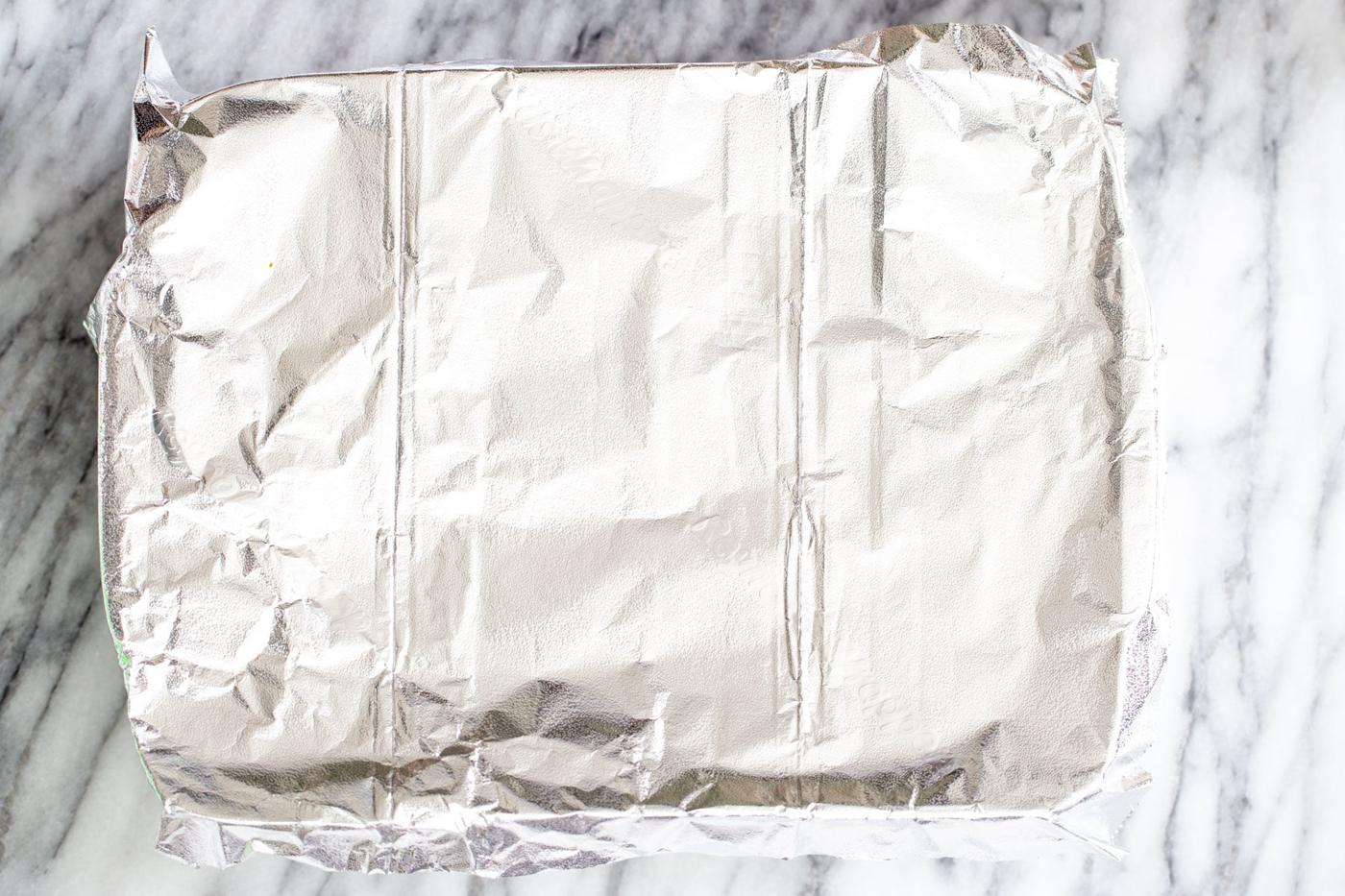 a casserole dish covered with aluminum foil