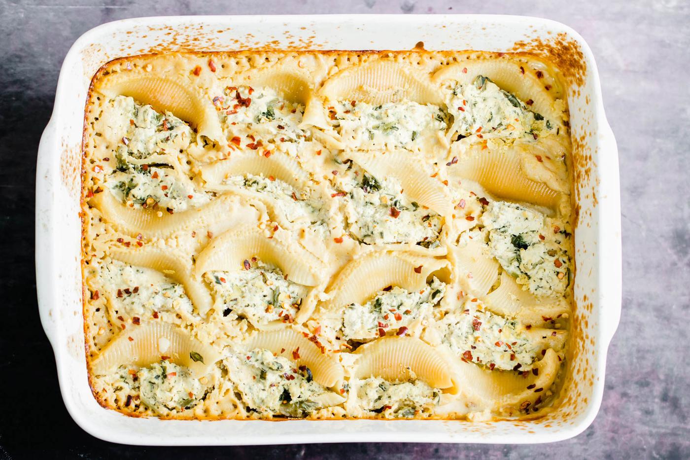 baked vegan stuffed shells in a casserole dish