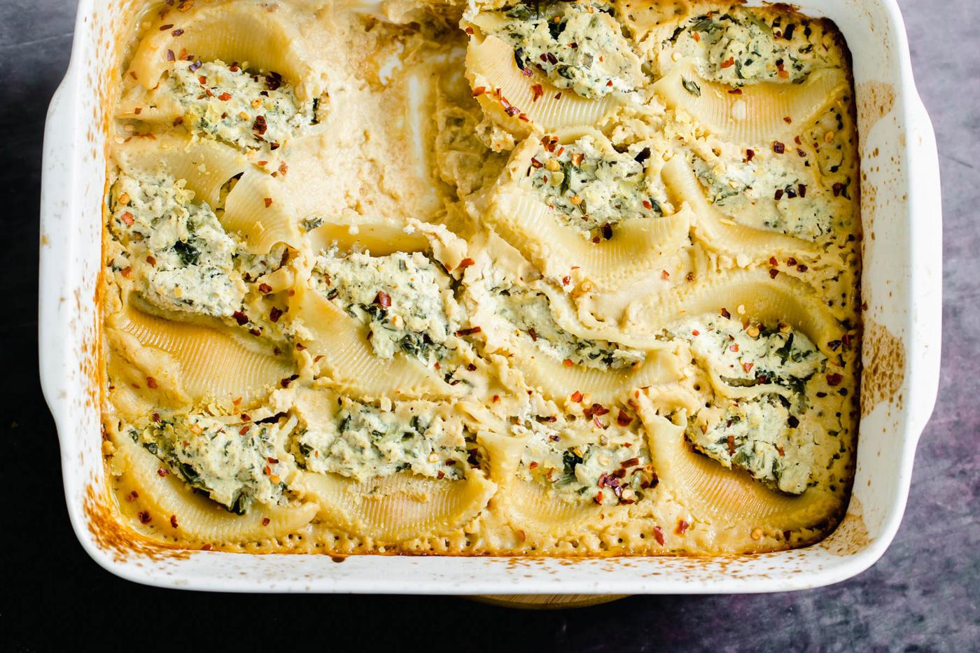 overhead shot of a casserole dish with vegan ricotta stuffed shells with butternut alfredo