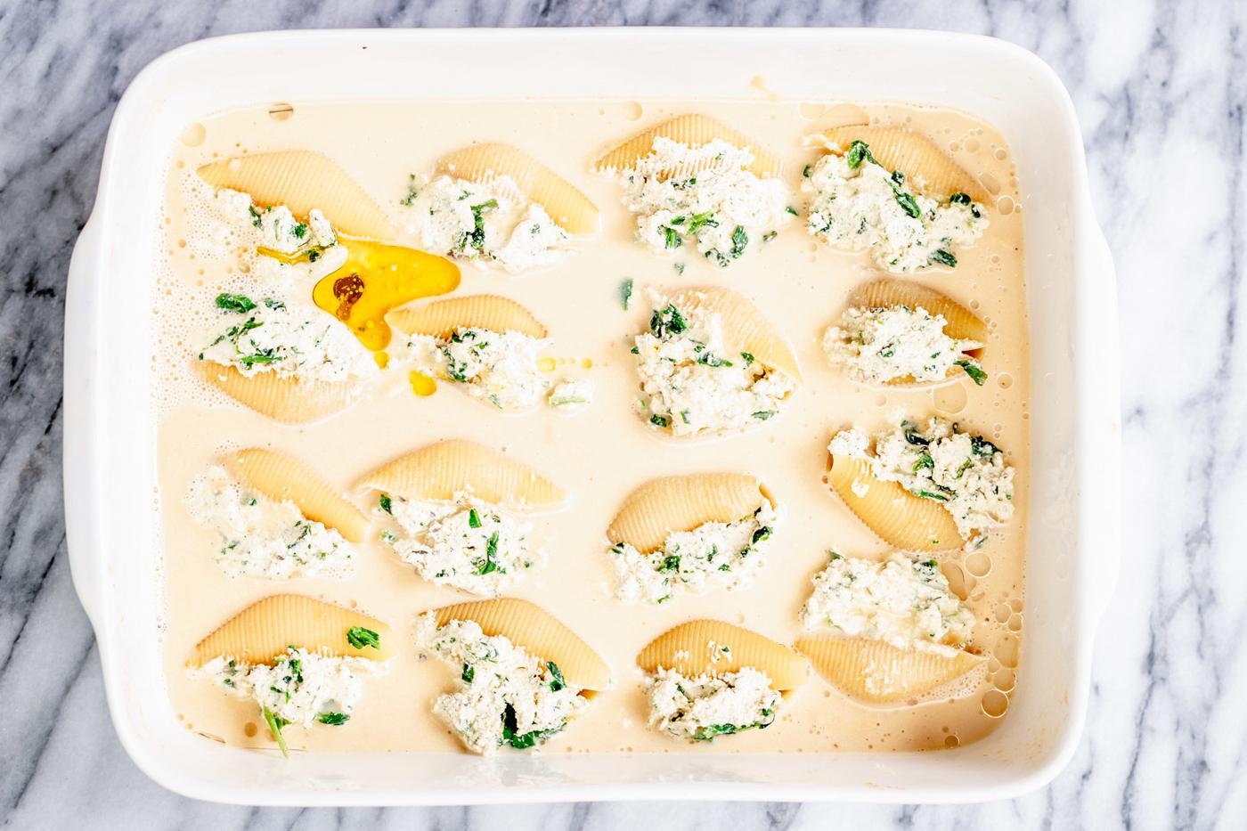 overhead shot of casserole dish with vegan stuffed shells before baking