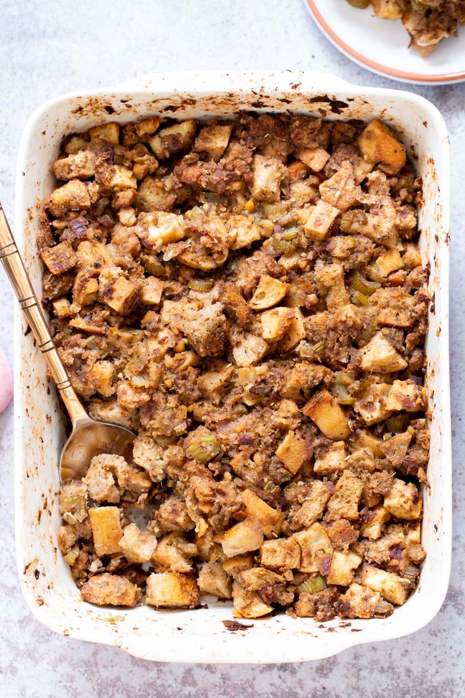 Vegan Stuffing with chickpea sausage in a white casserole dish