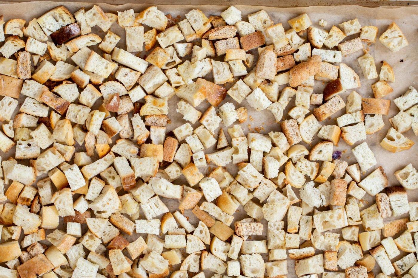 bread cubes toasting on a baking sheet
