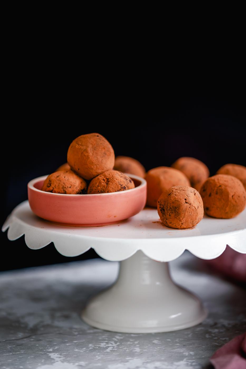 vegan tiramisu truffles rolled in cocoa powder presented on a cake stand