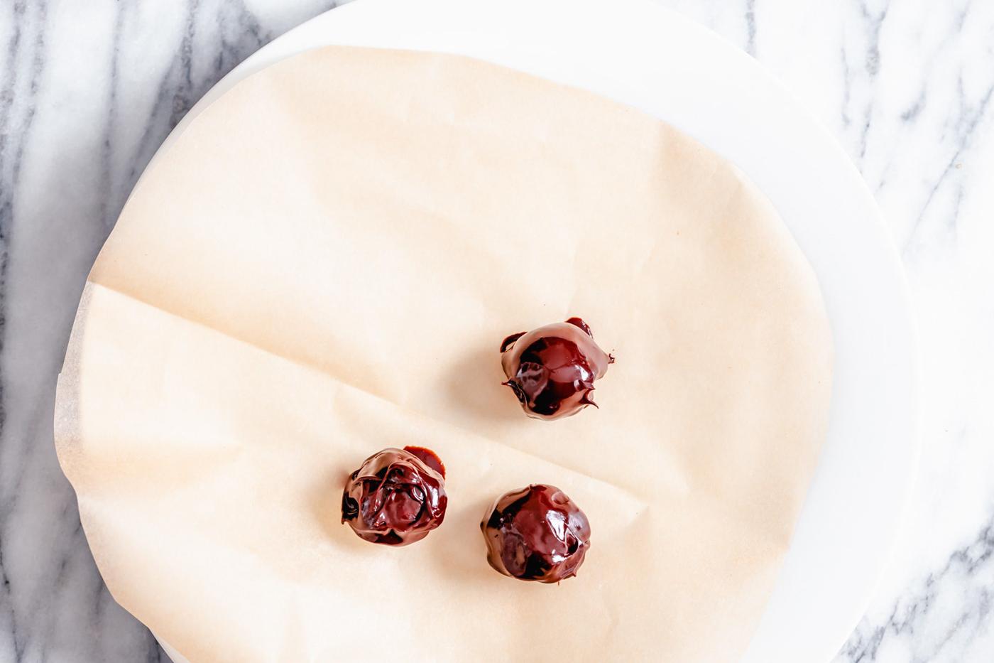 overhead shot of a plate with freshly coated vegan tiramisu truffles