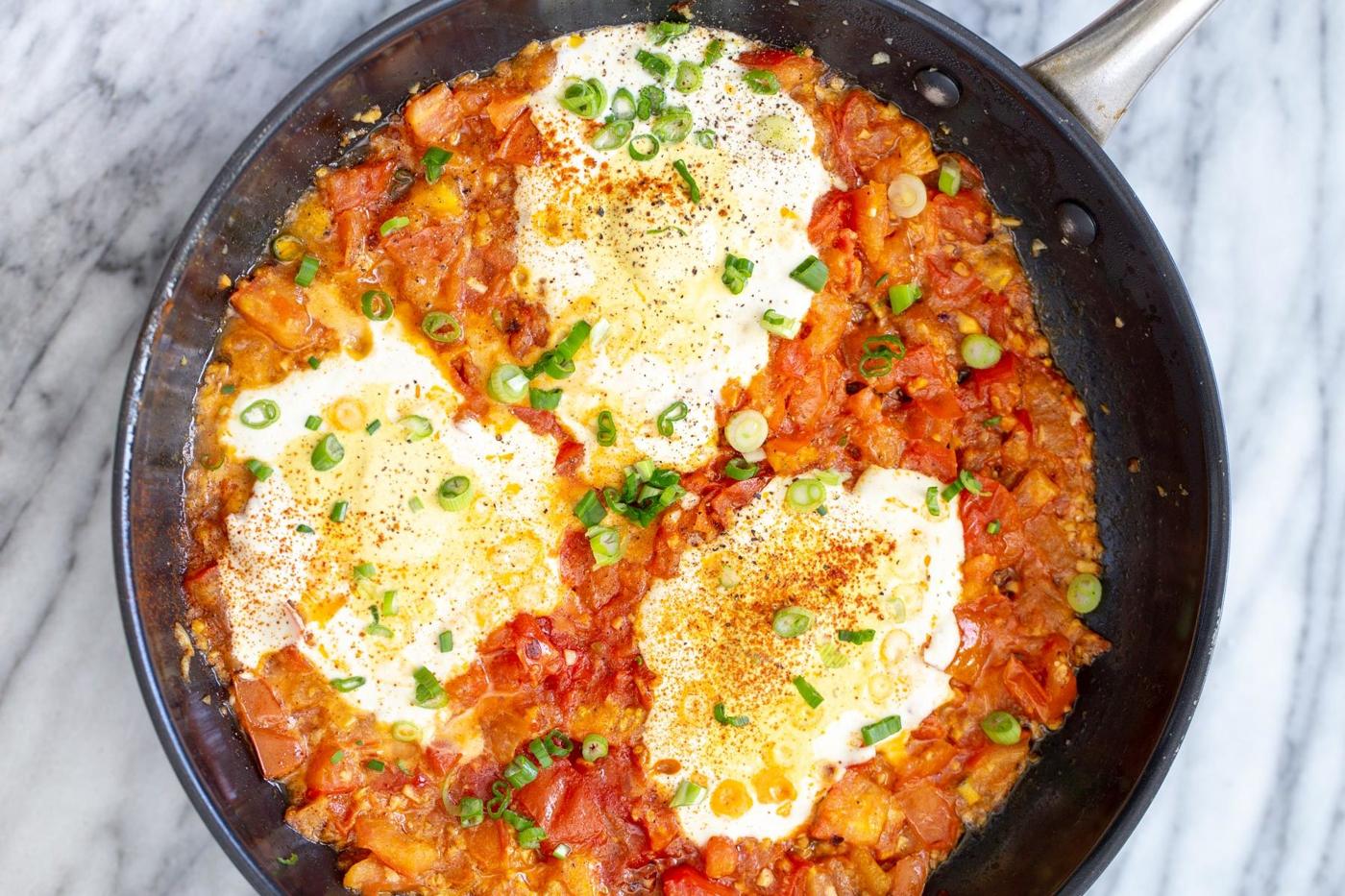 overhead shot of a skillet with vegan eggs in purgatory