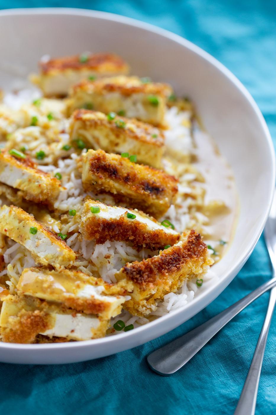 side view of a bowl of vegan tofu katsu curry served on rice