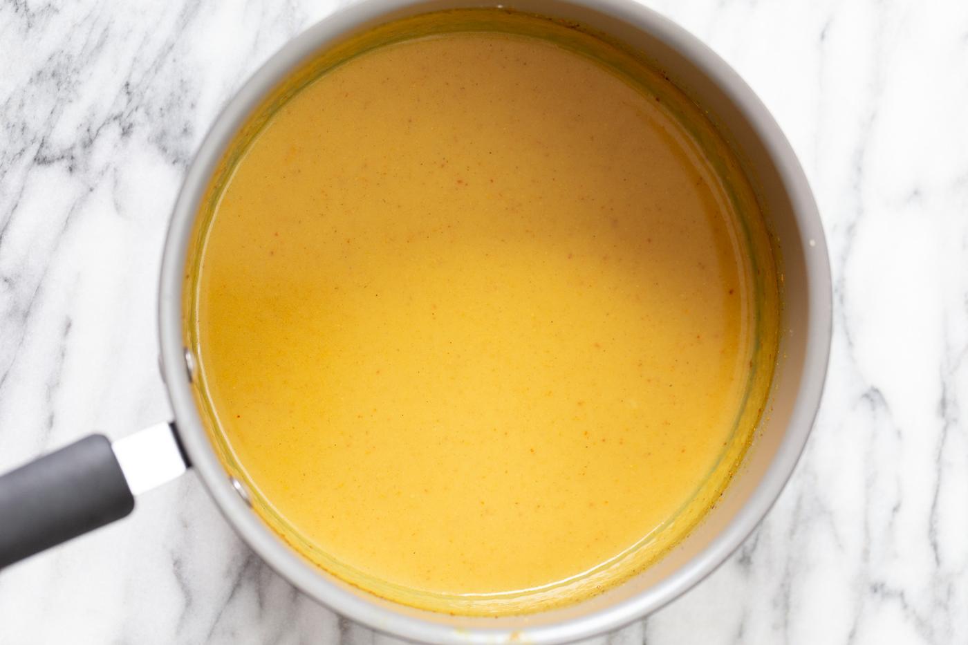 tofu katsu curry sauce in a saucepan on a marble kitchen counter