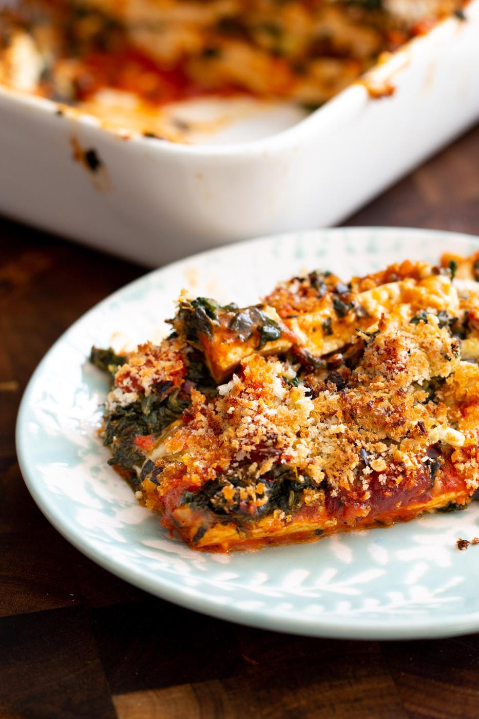 a serving of tofu bake with spinach, marinara sauce and breadcrumbs
