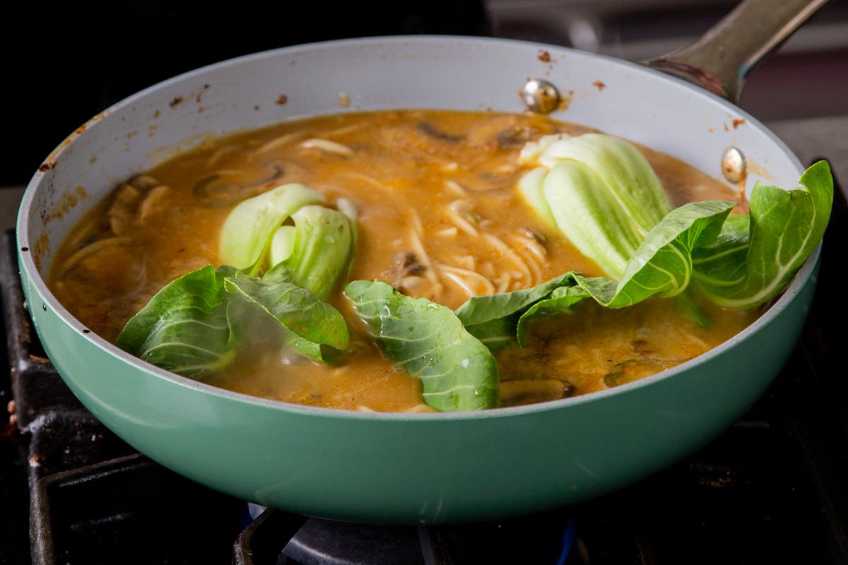 adding bok choy to the tonkotsu ramen stock