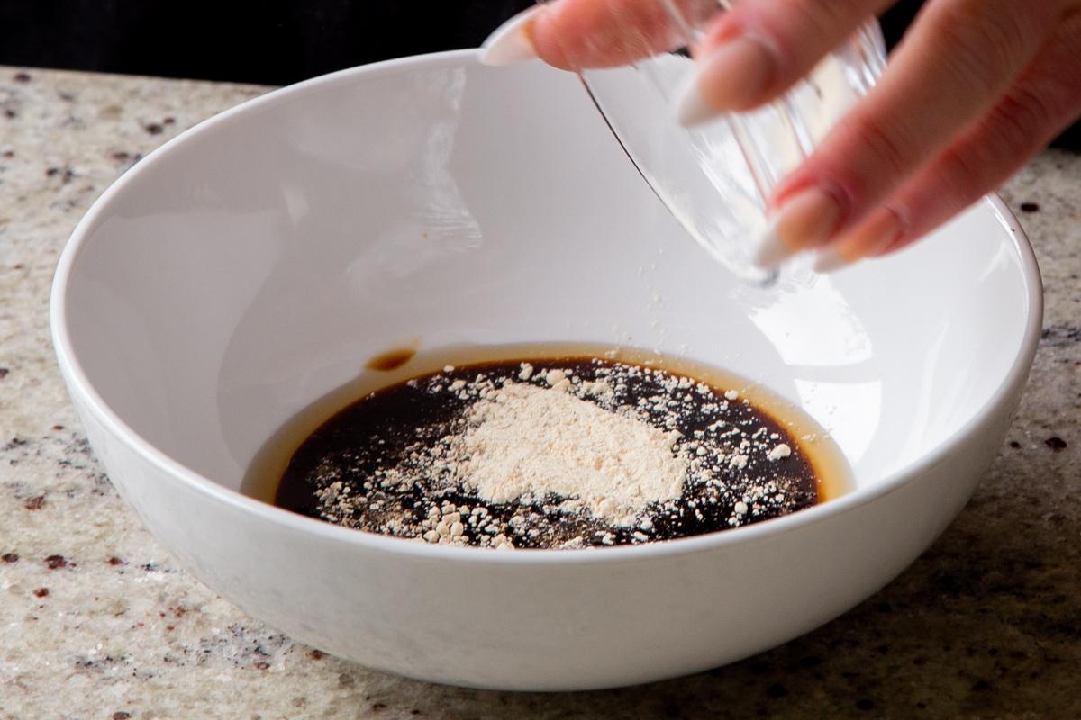 adding garlic powder to the tofu marinade