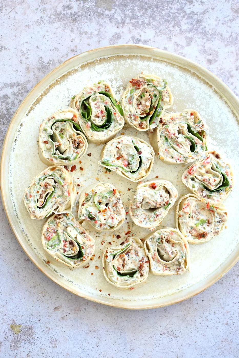Vegan Tortilla Roll Ups Recipe. Veggies and Sun-dried tomato are mixed in Tofu Herb Cream Cheese androlled to make Easy Tortilla pinwheels. Vegan Nutfree Recipe, can be gluten-free soy-free #Vegan#veganricha #tortillarollups #sundriedtotmatopinwheels