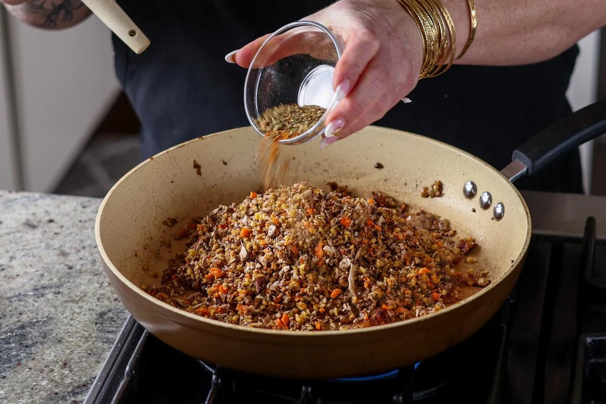 adding herbs and spices to the mixture