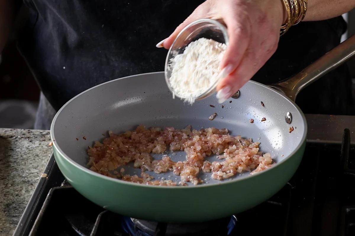 adding flour to the pan