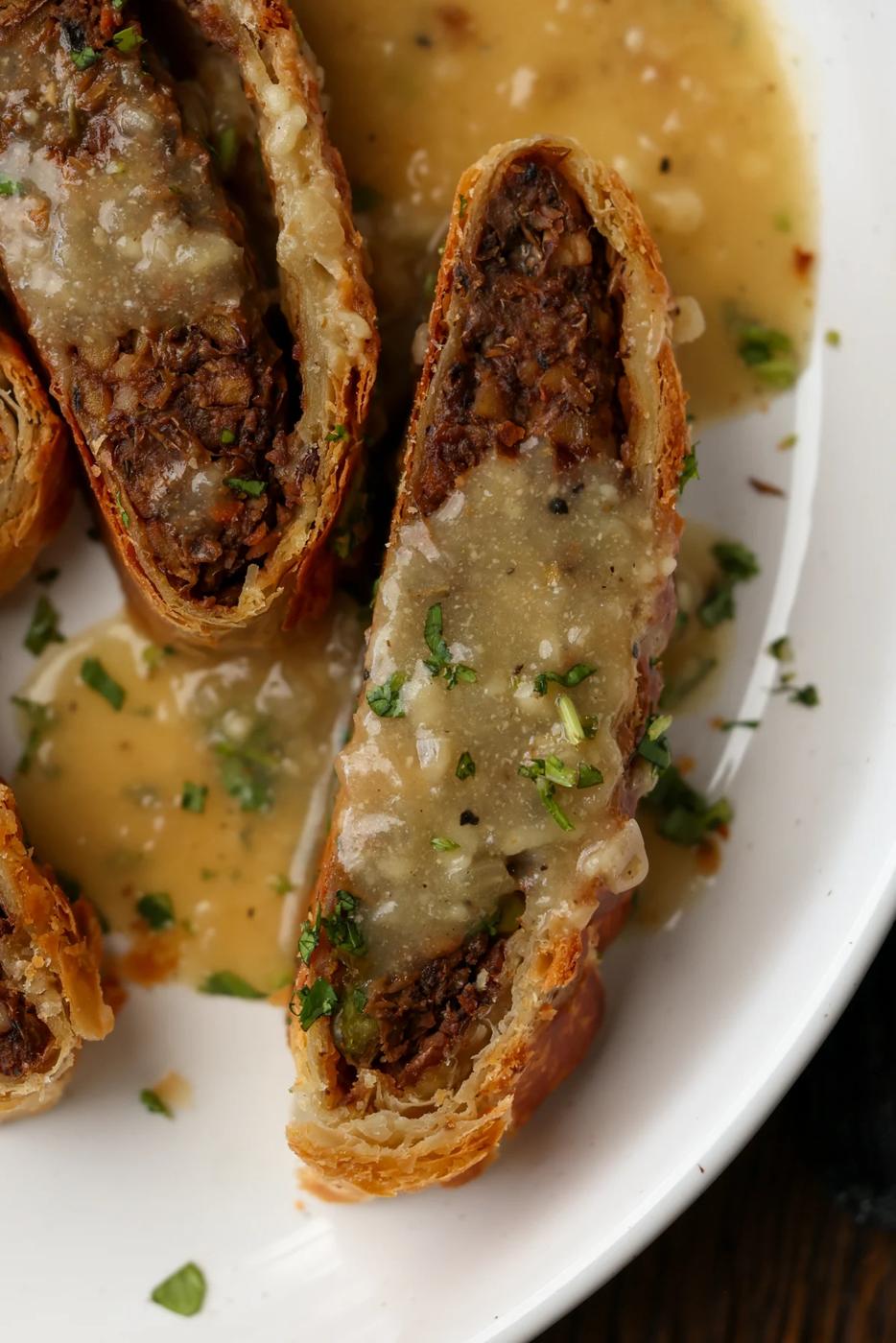 close-up of lentil wellington on a plate with gravy