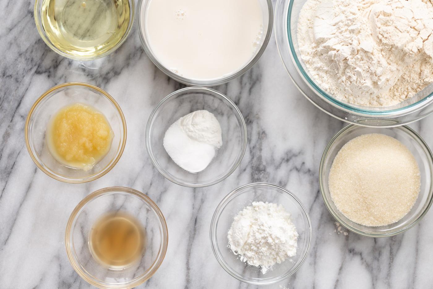 ingredients for making vegan white cake on a marble kitchen counter