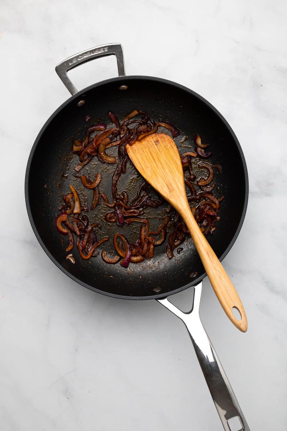 overhead shot of caramelized onion in a black frying pan