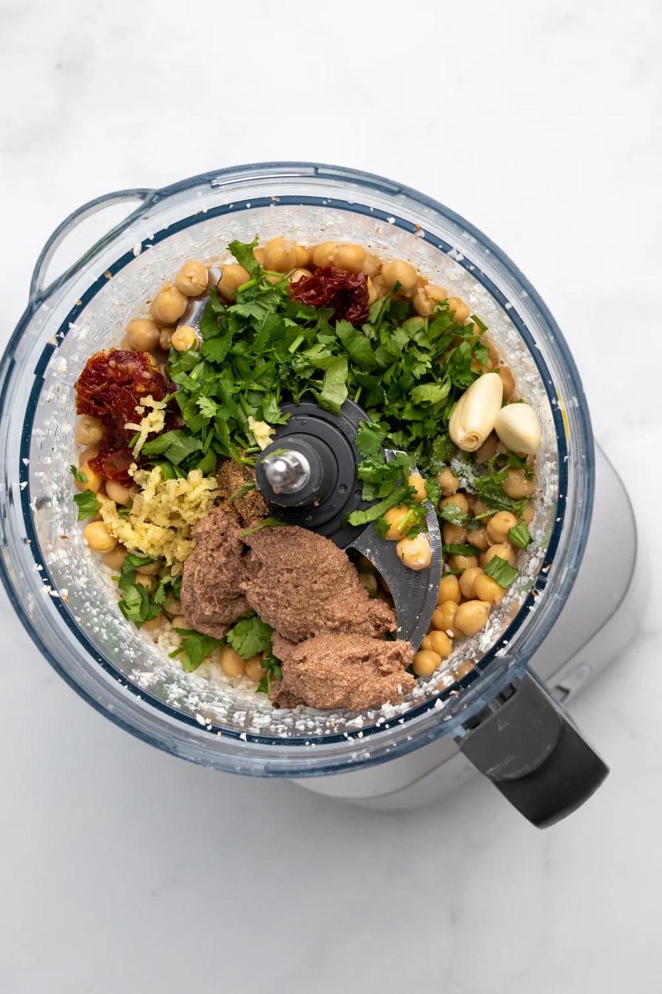 ingredients for making vegan chickpea burger patties in a food processor