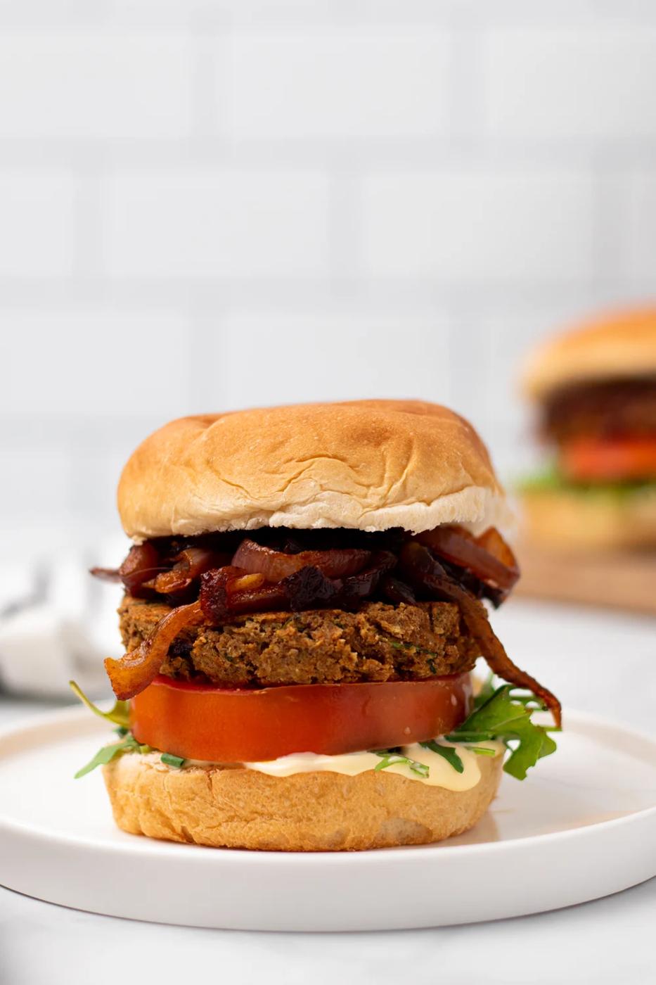side view of a vegan Middle Eastern Za'atar Spiced Chickpea Burger on a white plate