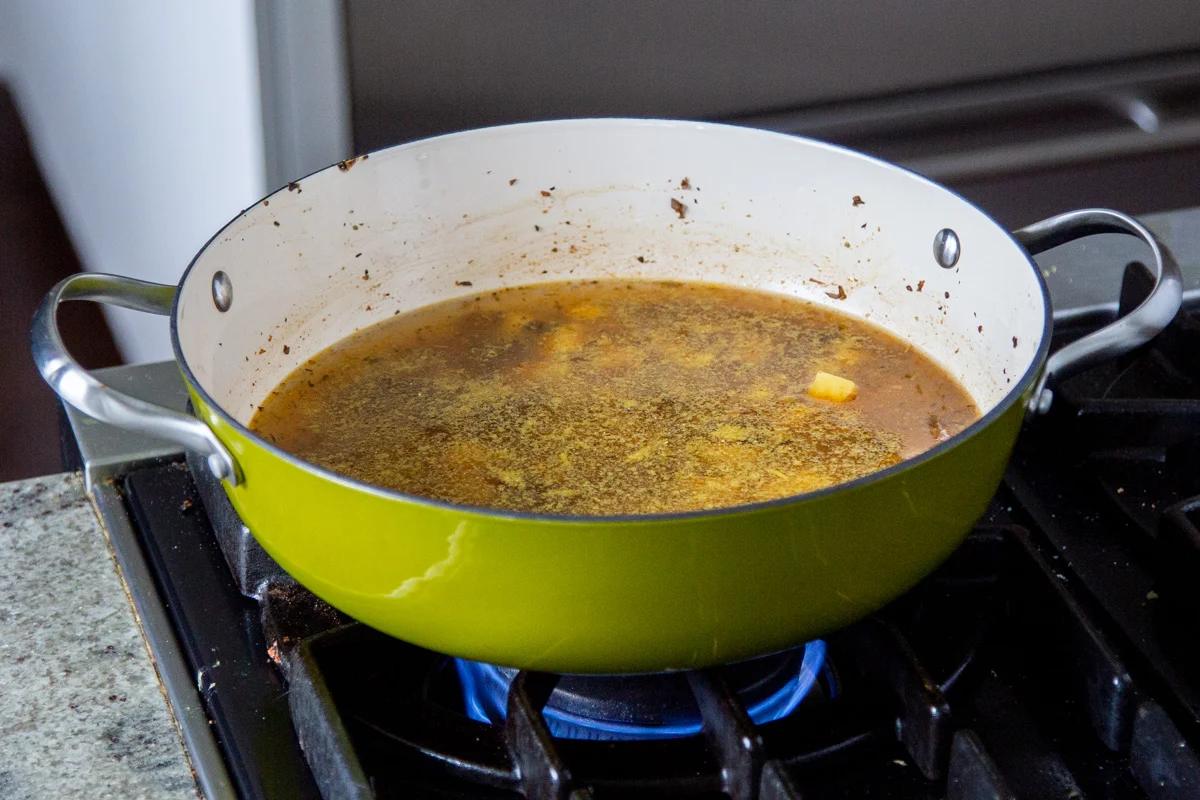 sausage and cubed potatoes simmering in a saucepan