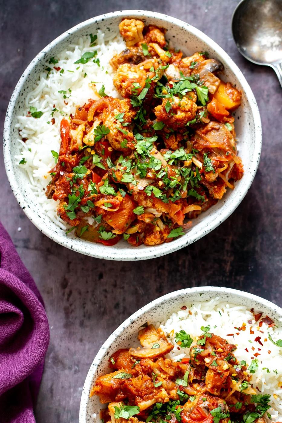 a bowl with rice topped with vegetable balti