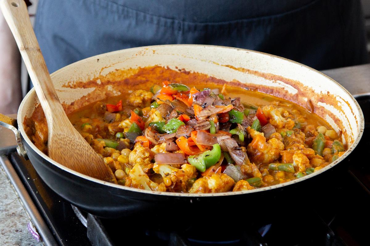 adding topping to the veggie mixture