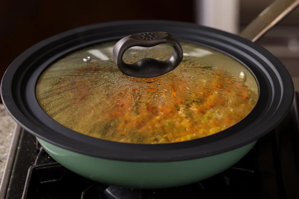 covered pan simmering on the stove