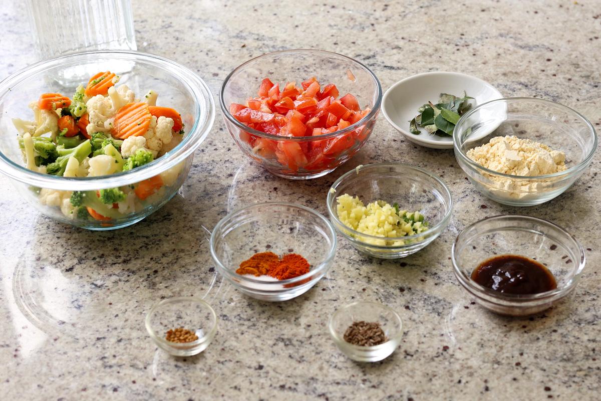 Sindhi kadhi ingredients in bowls on the kitchen counter