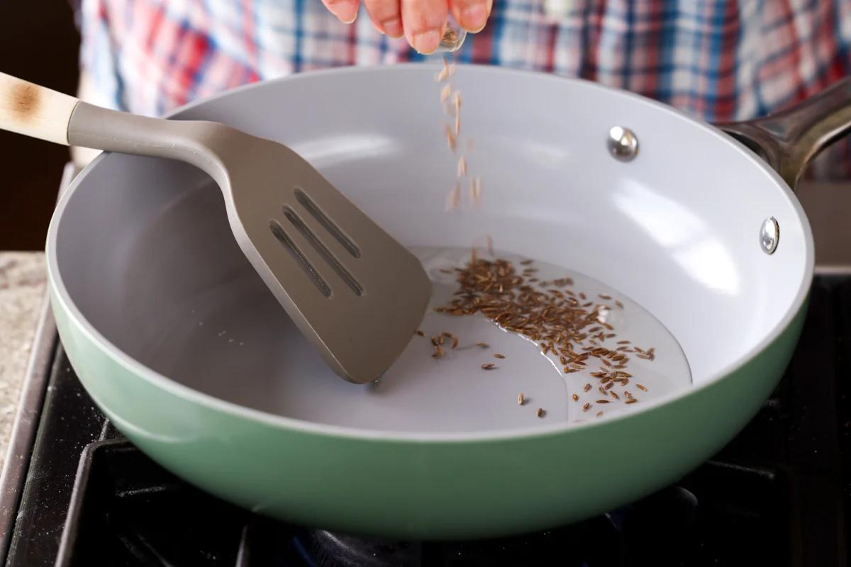 adding the whole spices to the pan