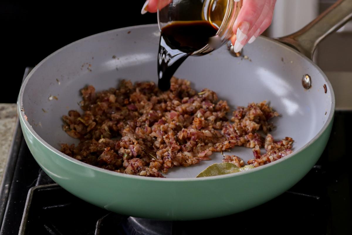 adding red wine to the pan