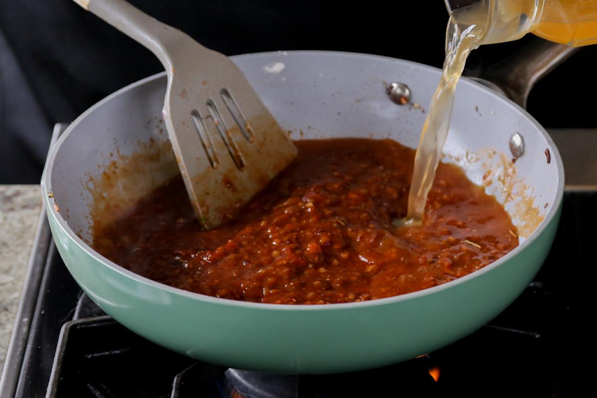 adding stock to the pan