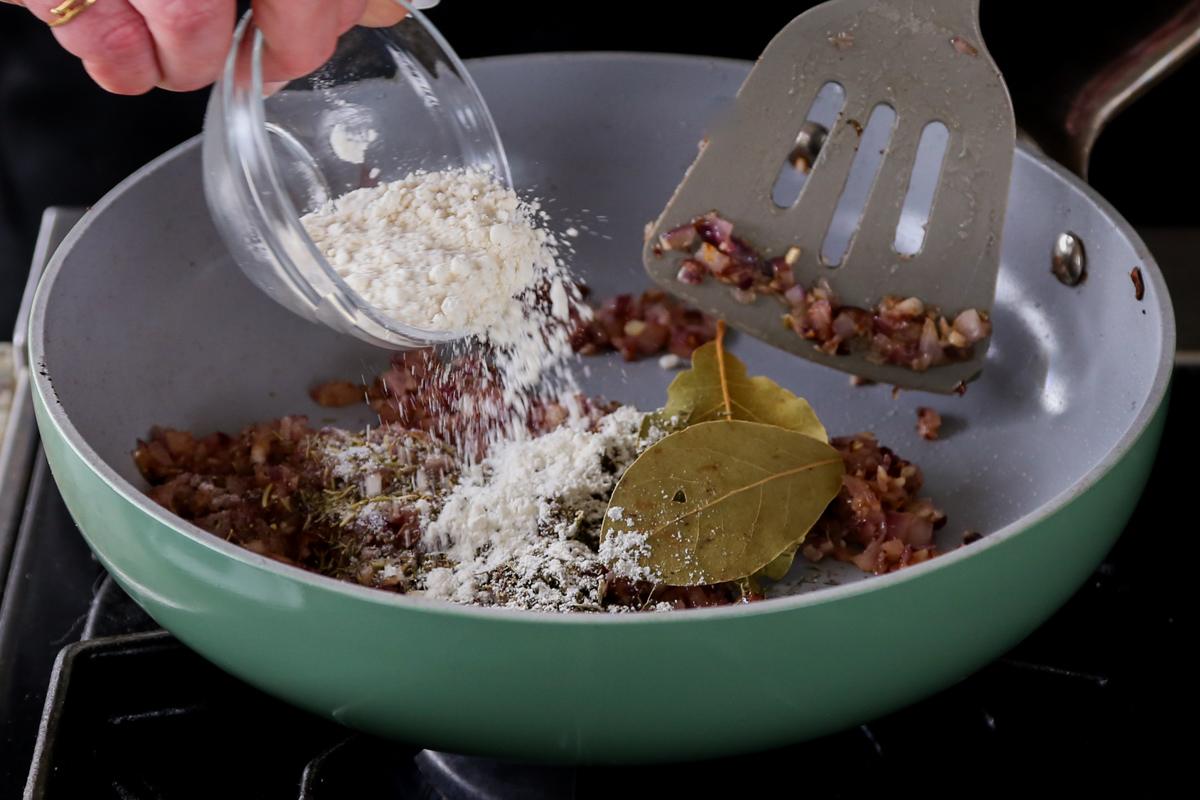 adding flour to the pan