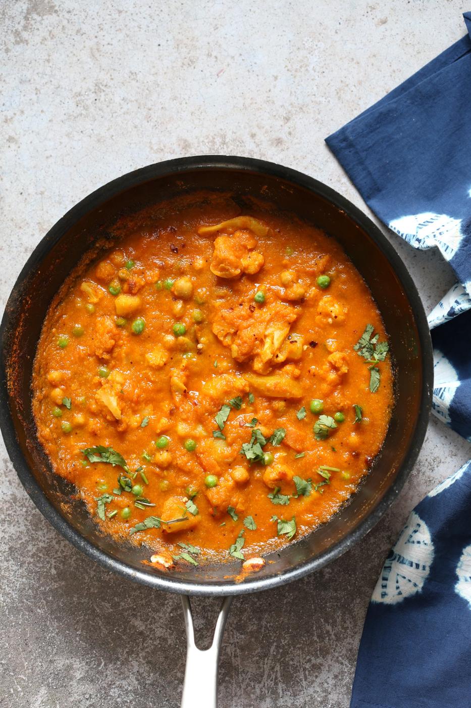 Vegetable Coconut Korma in Black skillet over conrete