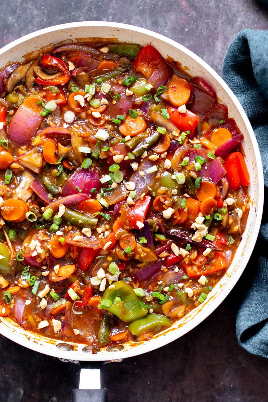 a sauteeing pan with vegetables simmering in hot spicy tangy Indo Chinese Sauce