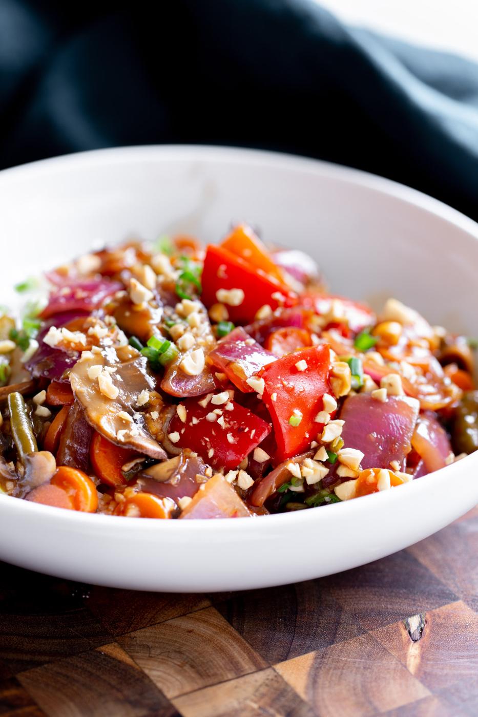 side view of a plate with sweet & sour Indo Chinese veggies served with rice