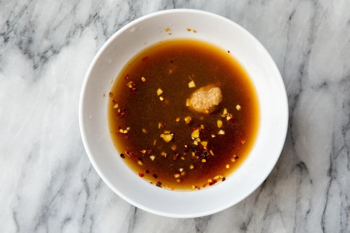 sweet spicy dressing in a small white bowl