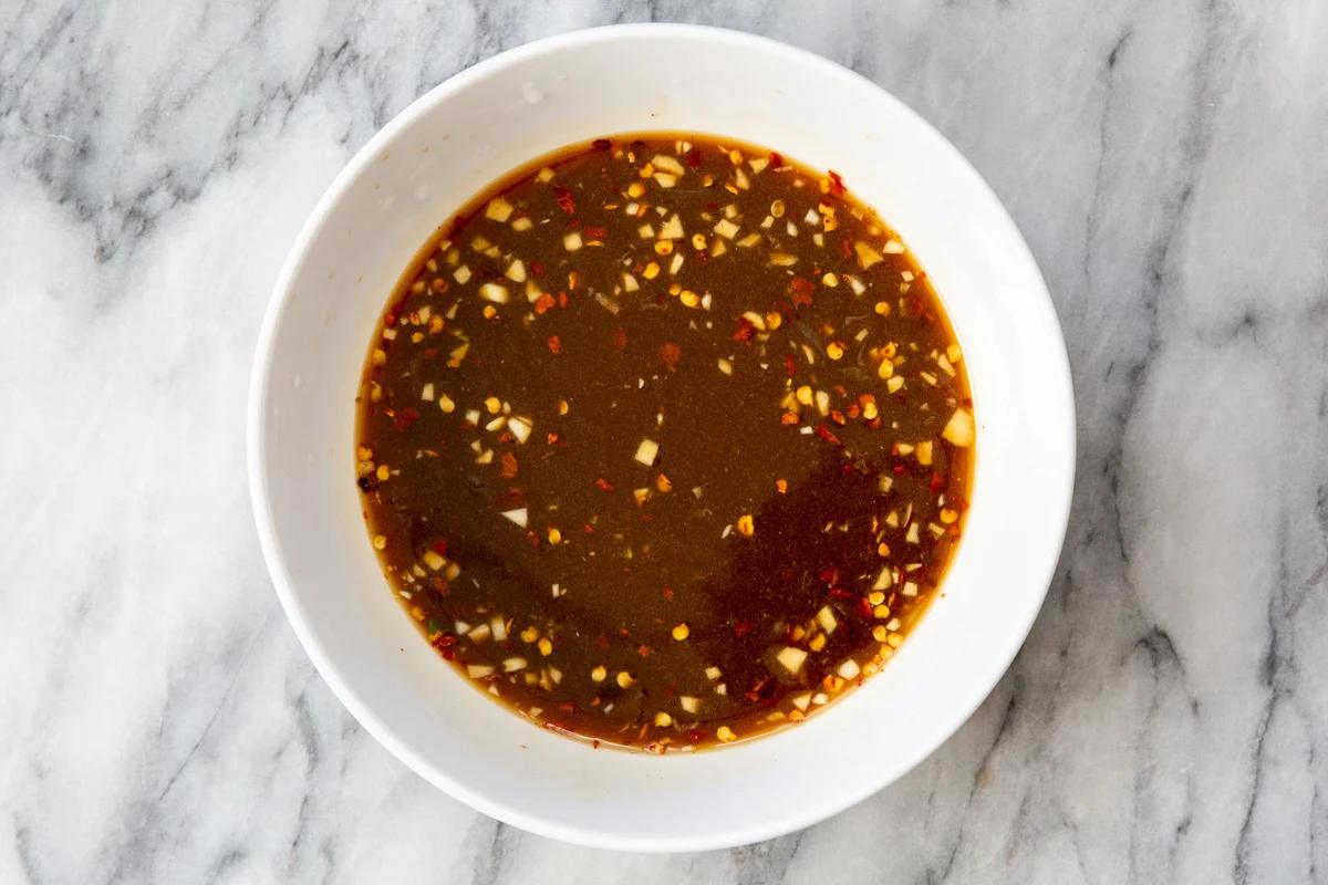 sweet and spicy dressing for lentil bowls in a small white dish