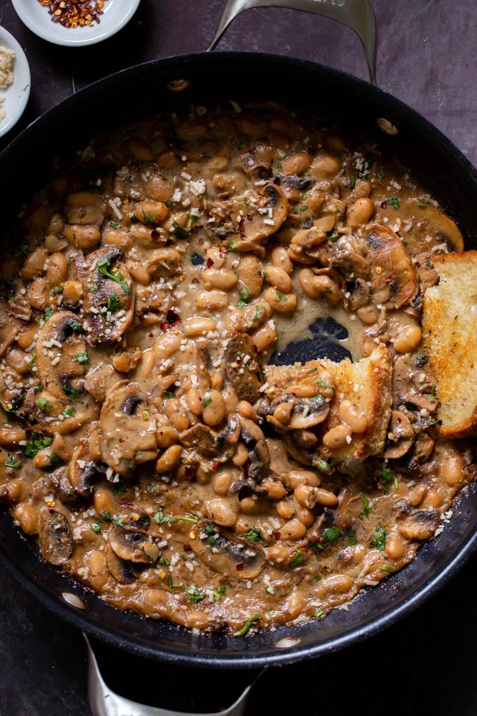 white bean stroganoff in the pan after dipping with toast